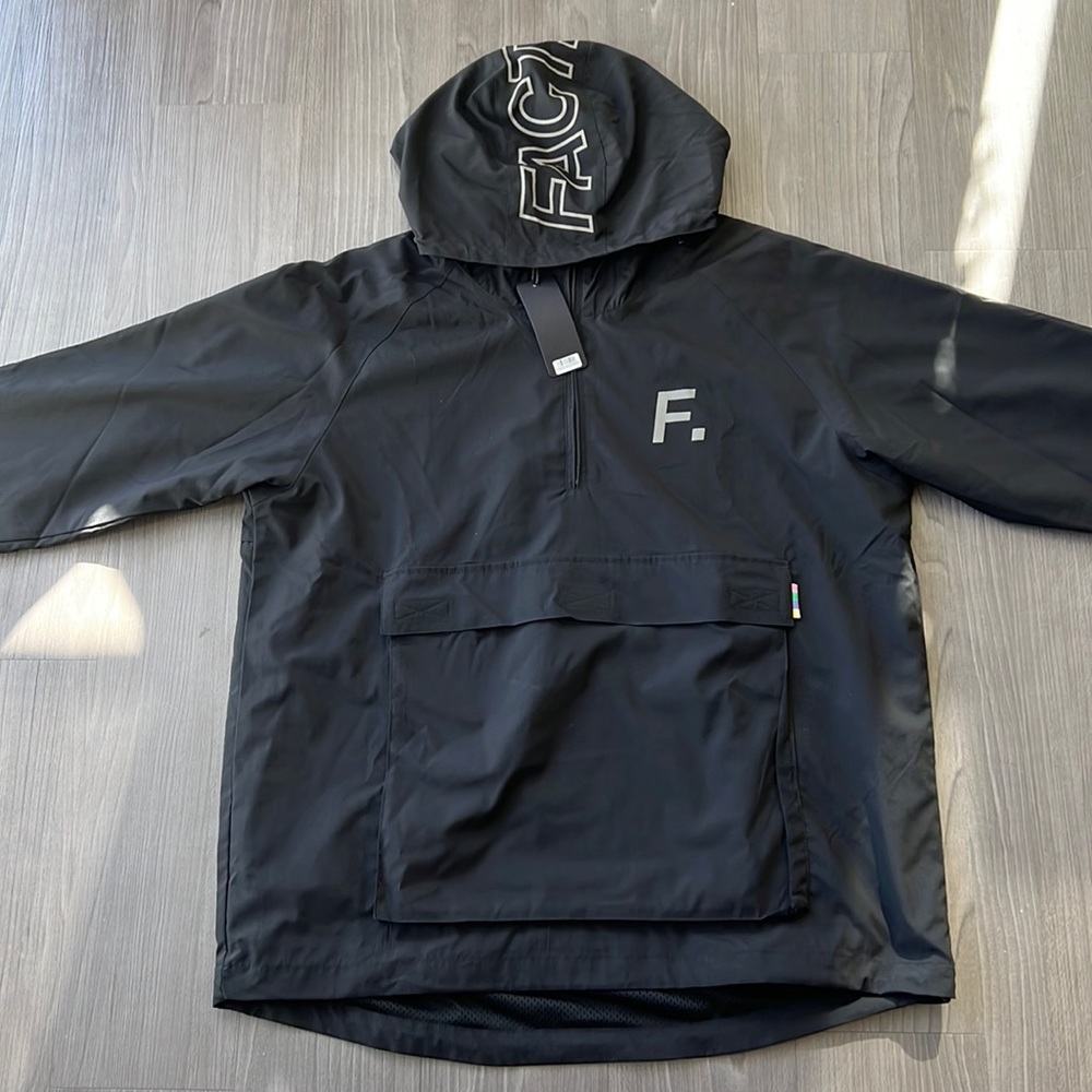 Fact. Brand 1/4 Zip Pullover with Pouch in Black. Brand New with Tags.